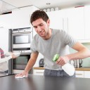 young-happy-man-helping-smiling-wife-clean-kitchen