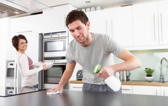 young-happy-man-helping-smiling-wife-clean-kitchen